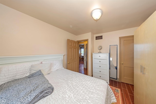 bedroom with dark wood-type flooring