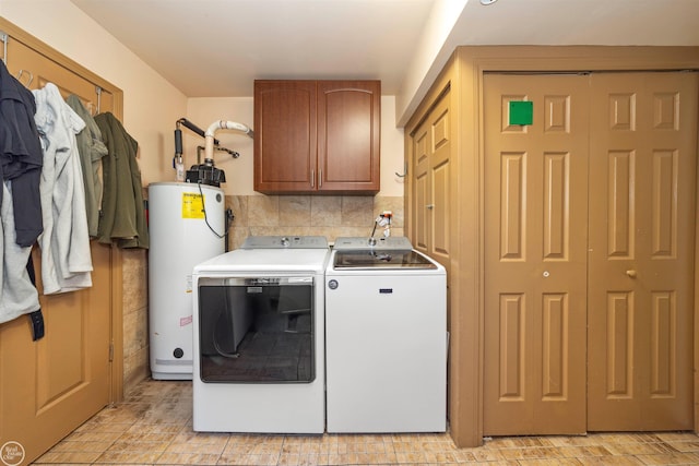 laundry room featuring cabinets, separate washer and dryer, and water heater