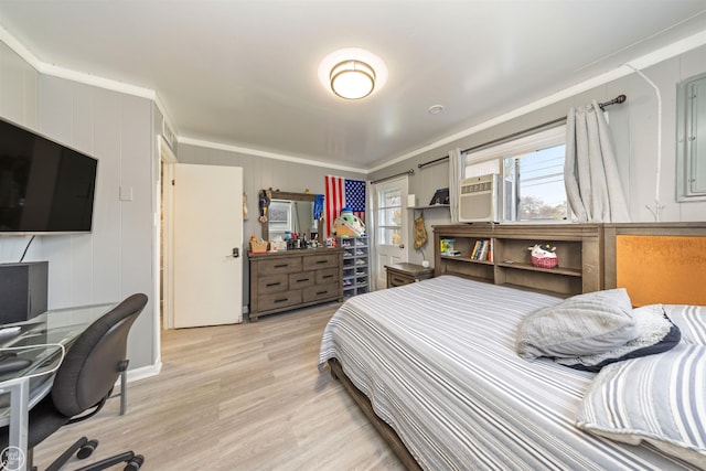 bedroom with wood walls, cooling unit, ornamental molding, and light hardwood / wood-style flooring