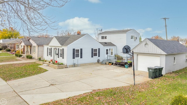 rear view of house featuring a lawn, an outbuilding, and a garage