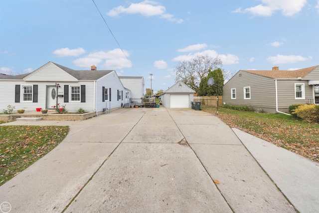 view of front of home with a garage and an outdoor structure