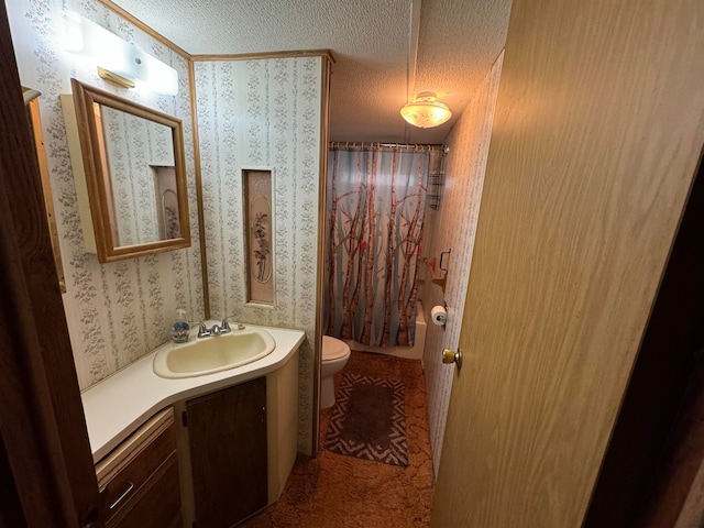 full bathroom with vanity, shower / bath combination with curtain, a textured ceiling, and toilet