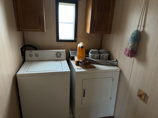 laundry area featuring cabinets and washing machine and clothes dryer