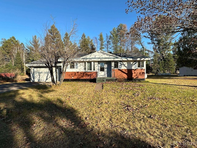 view of front of property with a garage and a front yard