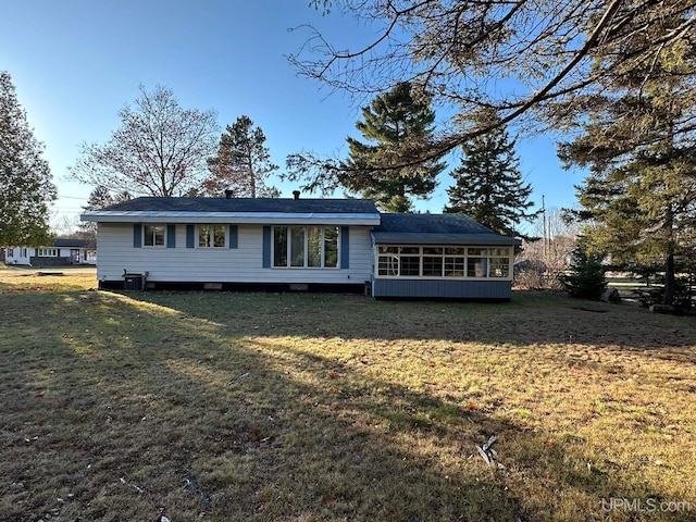 view of front of property featuring cooling unit and a front lawn