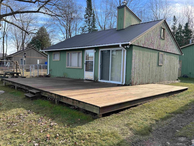 back of house featuring a yard and a wooden deck