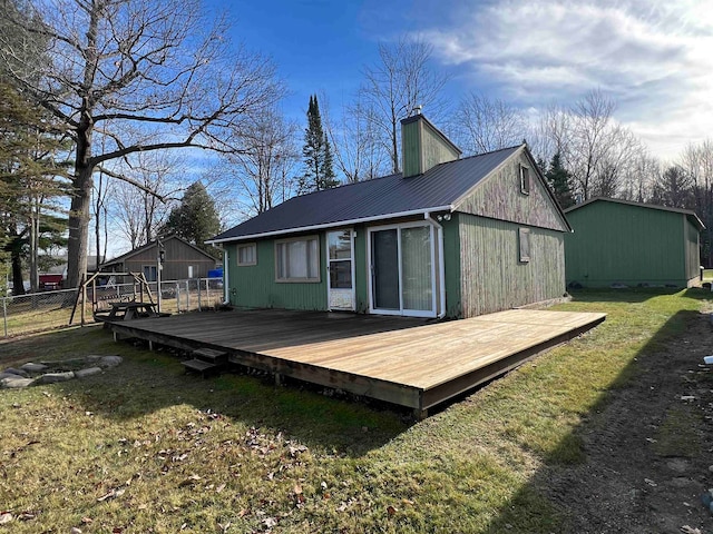 back of house featuring a deck and a yard