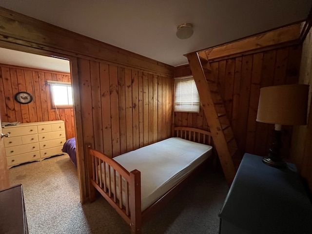 bedroom featuring carpet and wooden walls