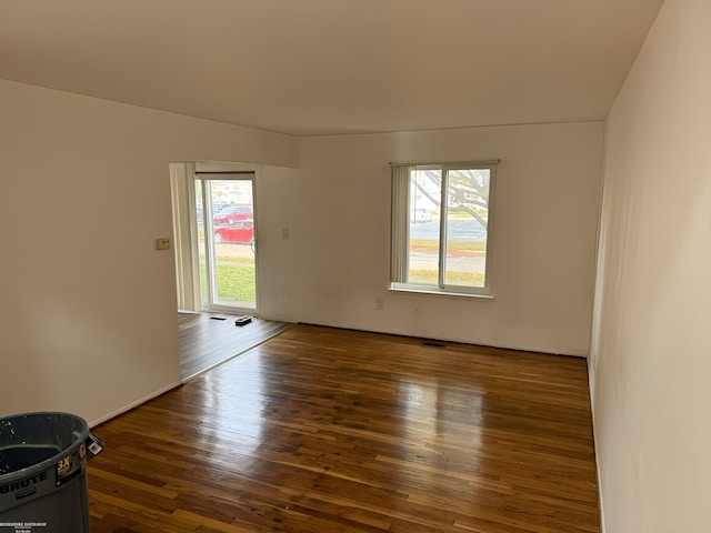 spare room featuring dark hardwood / wood-style floors