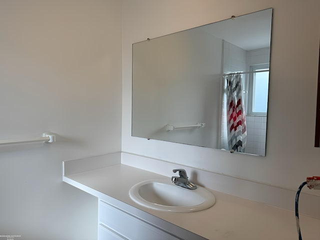 bathroom with vanity and walk in shower