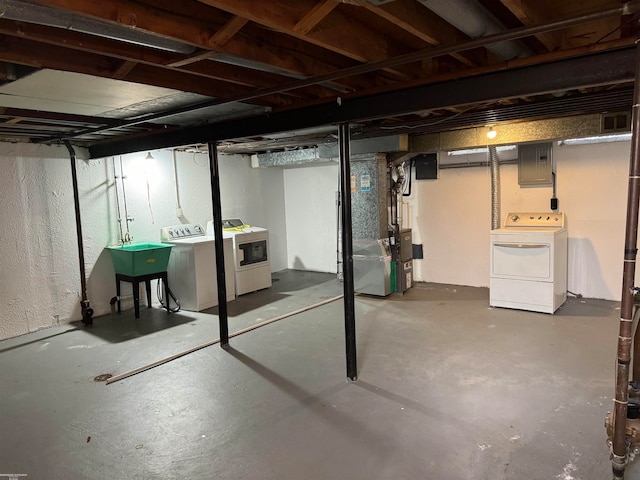 basement featuring heating unit and washing machine and clothes dryer