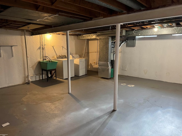 basement with washing machine and dryer and heating unit