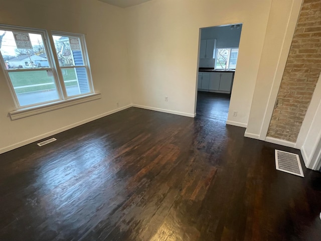 empty room featuring dark wood-type flooring