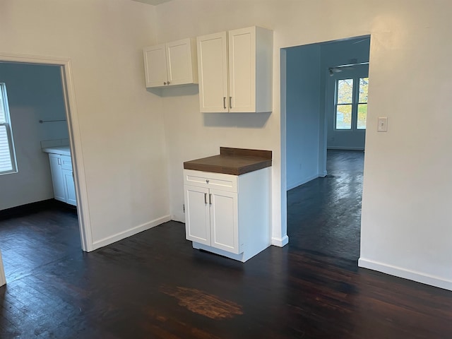 kitchen featuring white cabinets and dark hardwood / wood-style floors