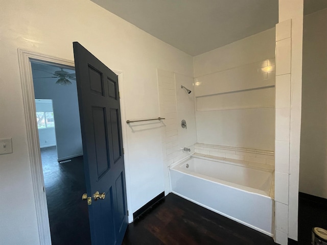 bathroom with shower / bathing tub combination, hardwood / wood-style flooring, and ceiling fan