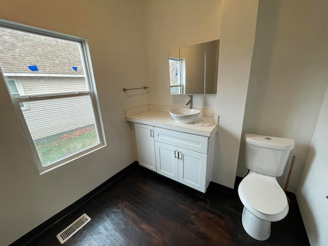 bathroom with vanity, toilet, and wood-type flooring