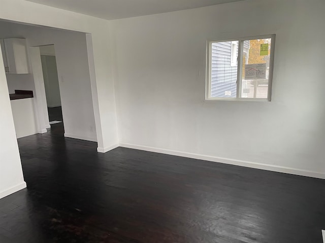 spare room featuring dark hardwood / wood-style flooring