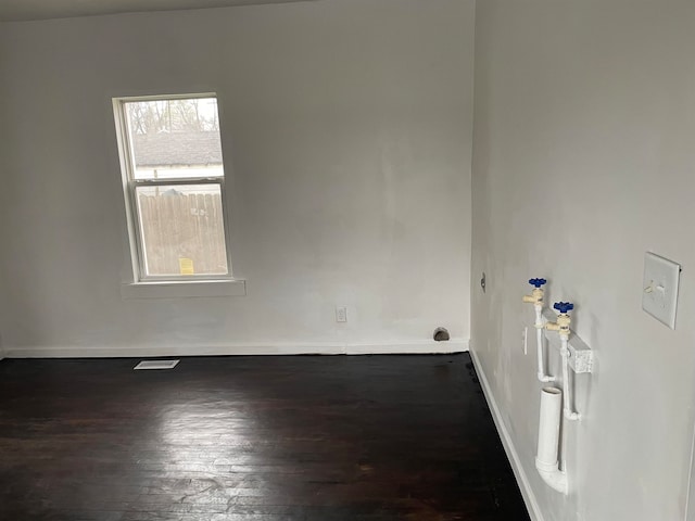 empty room with dark hardwood / wood-style floors