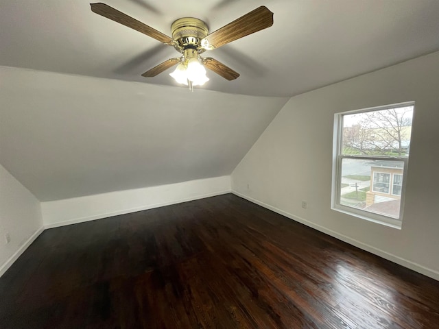 additional living space with dark hardwood / wood-style floors, vaulted ceiling, and ceiling fan