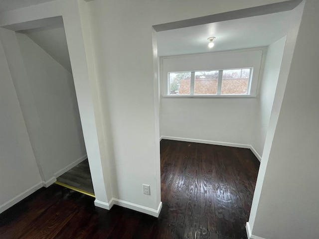 unfurnished room featuring dark wood-type flooring