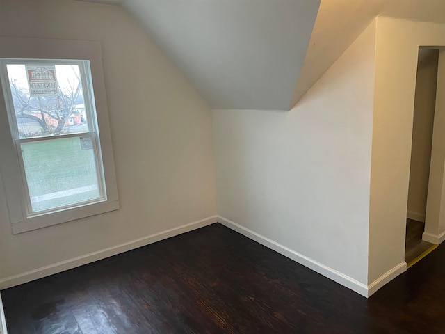 bonus room featuring dark hardwood / wood-style floors and vaulted ceiling