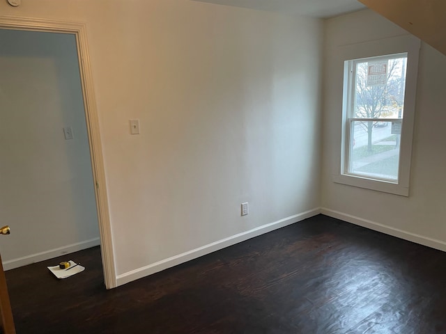 unfurnished room with dark hardwood / wood-style flooring