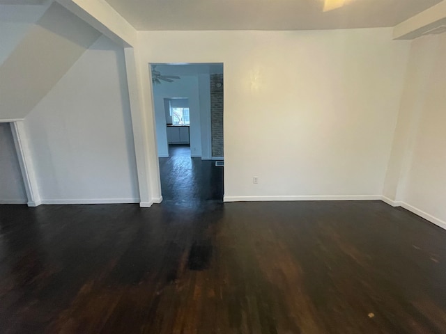 empty room with ceiling fan and dark wood-type flooring