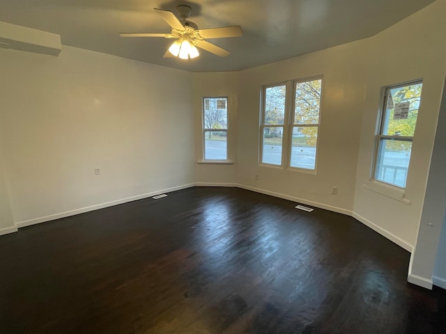 empty room featuring dark hardwood / wood-style floors and ceiling fan