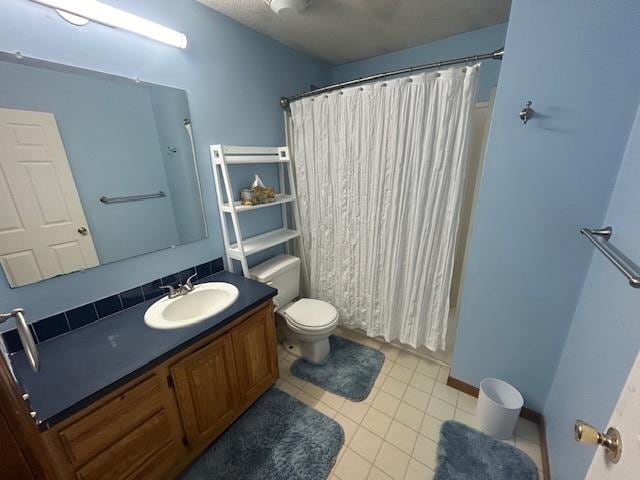 bathroom with tile patterned floors, vanity, toilet, and a shower with curtain