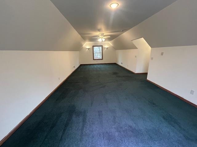 bonus room with ceiling fan, vaulted ceiling, and dark colored carpet