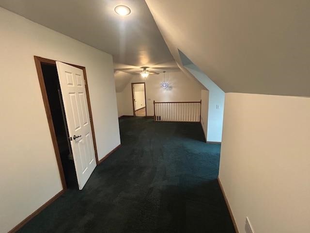 bonus room with ceiling fan, dark carpet, and lofted ceiling