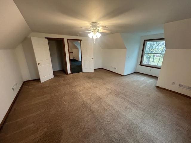 bonus room with carpet flooring, vaulted ceiling, and ceiling fan