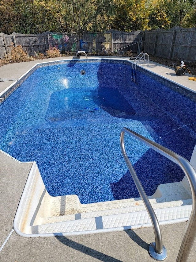 view of pool with a diving board