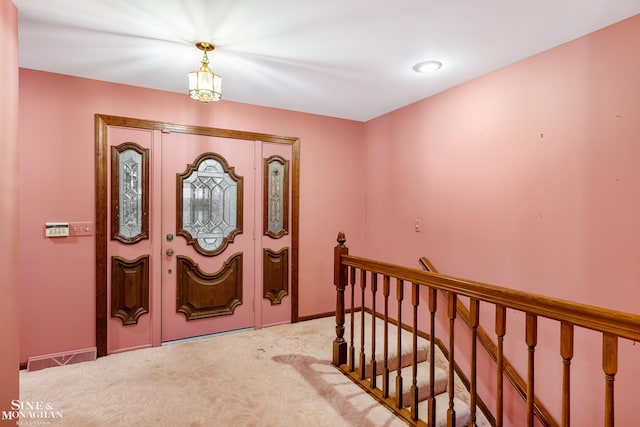 entryway featuring light carpet