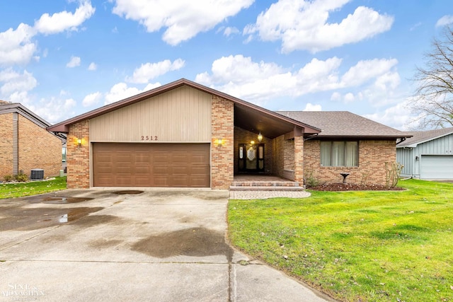 view of front of home with a front yard, a garage, and cooling unit