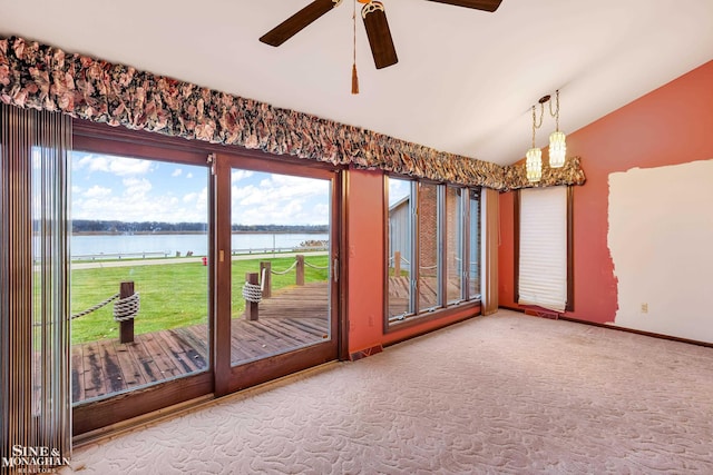 interior space featuring plenty of natural light, ceiling fan, a water view, and vaulted ceiling