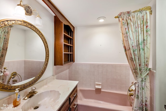 bathroom with a tub and vanity