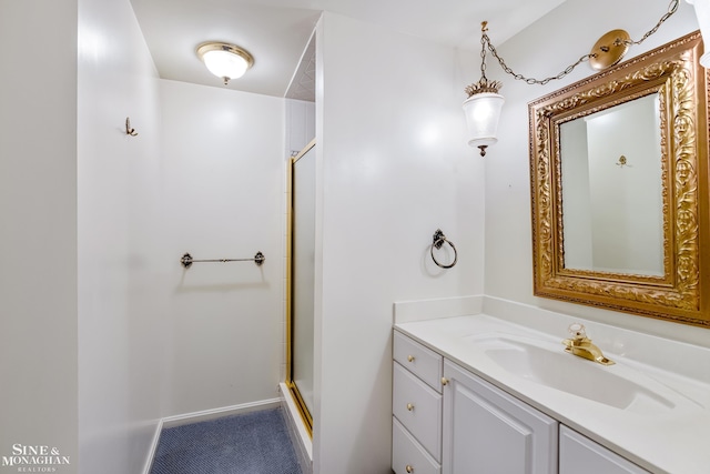 bathroom with vanity and a shower with shower door