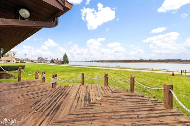 deck featuring a water view and a lawn