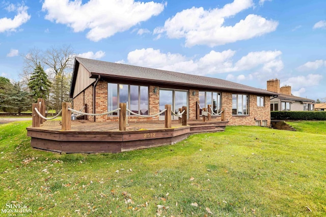 back of house featuring a lawn and a wooden deck