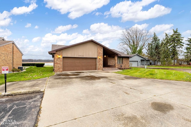 view of front of property with a garage, central air condition unit, and a front lawn