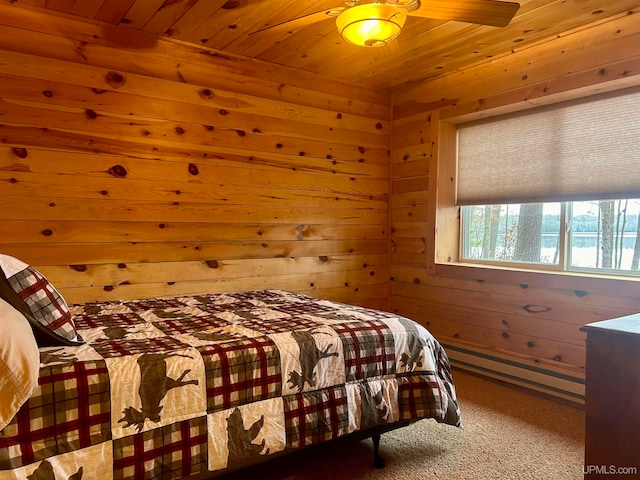 carpeted bedroom with ceiling fan, wood walls, wooden ceiling, and baseboard heating