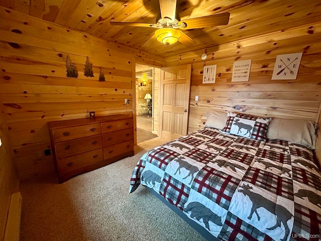 bedroom with light carpet, wooden ceiling, ceiling fan, and wooden walls