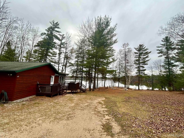 view of yard featuring a deck with water view