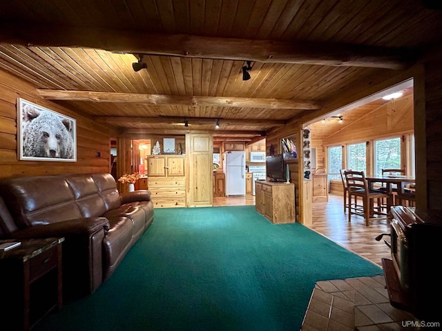 living room featuring beamed ceiling, light hardwood / wood-style floors, wooden walls, and wooden ceiling