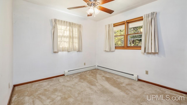 carpeted spare room with baseboard heating and ceiling fan