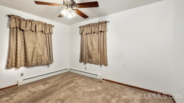 carpeted spare room with baseboard heating and ceiling fan