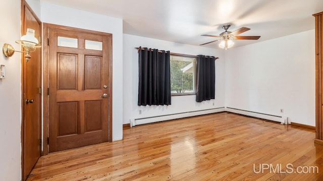 foyer featuring ceiling fan, a baseboard radiator, and light hardwood / wood-style flooring