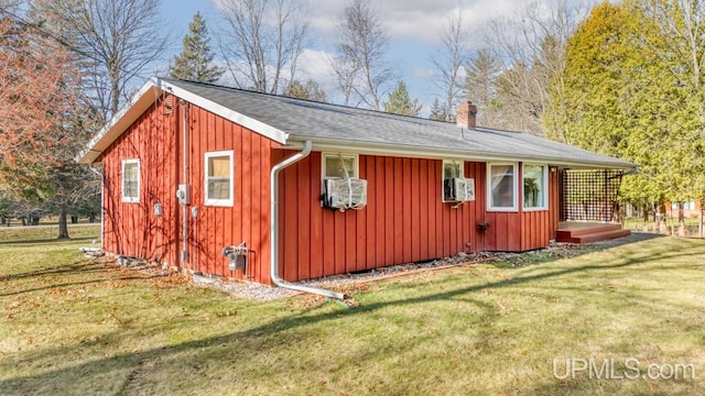 view of outbuilding featuring a lawn