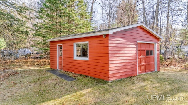 view of outbuilding featuring a lawn